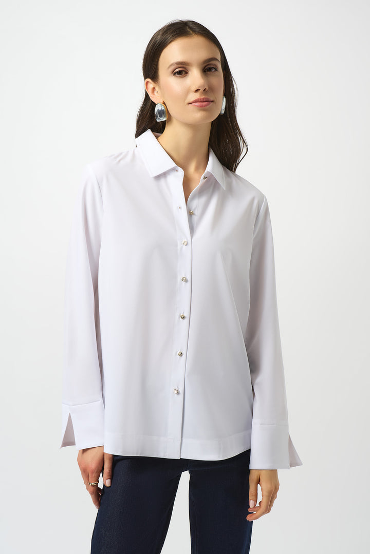 Woman wearing a white button-up shirt against a white background