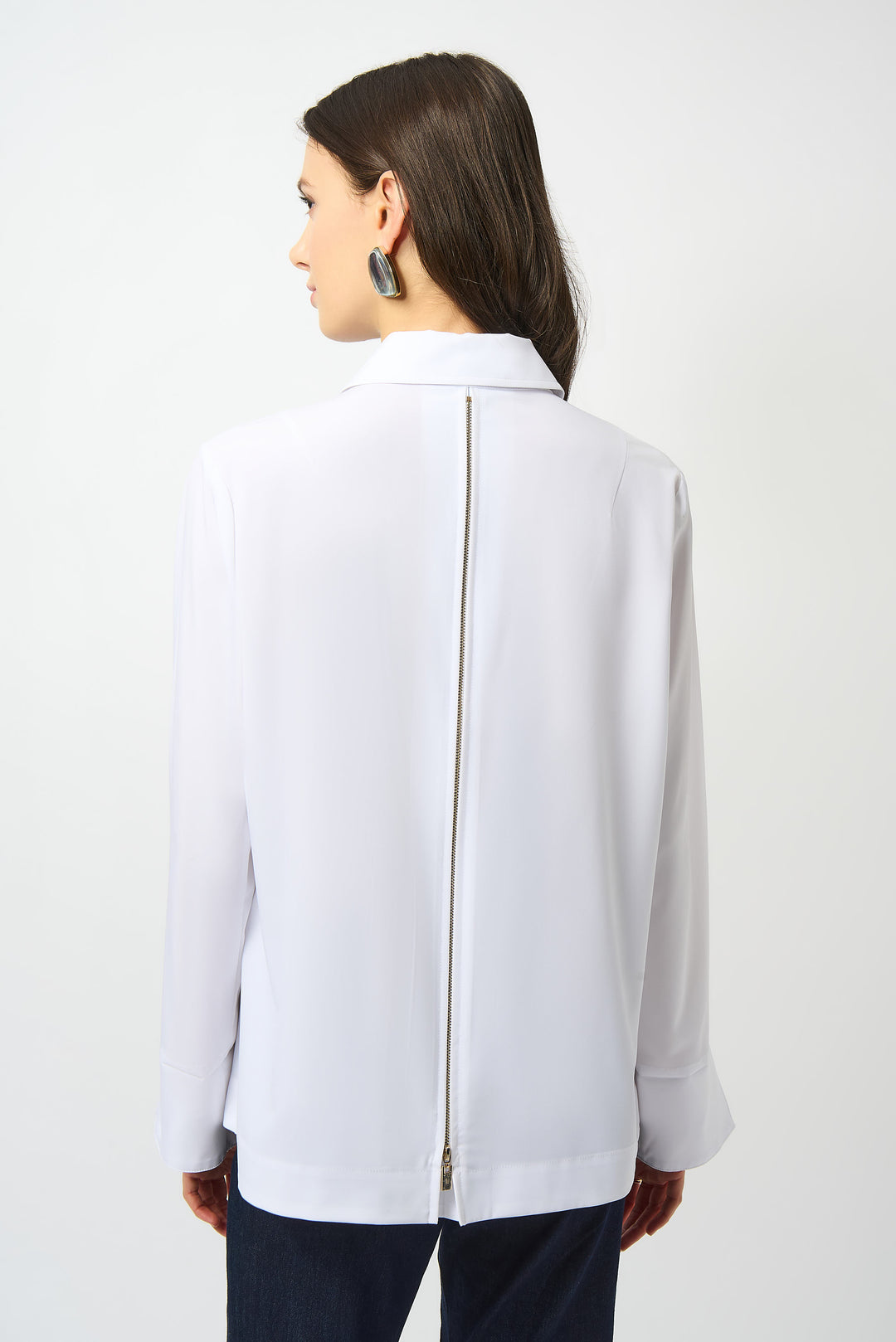 Woman wearing a white blouse with a zipper on a white background