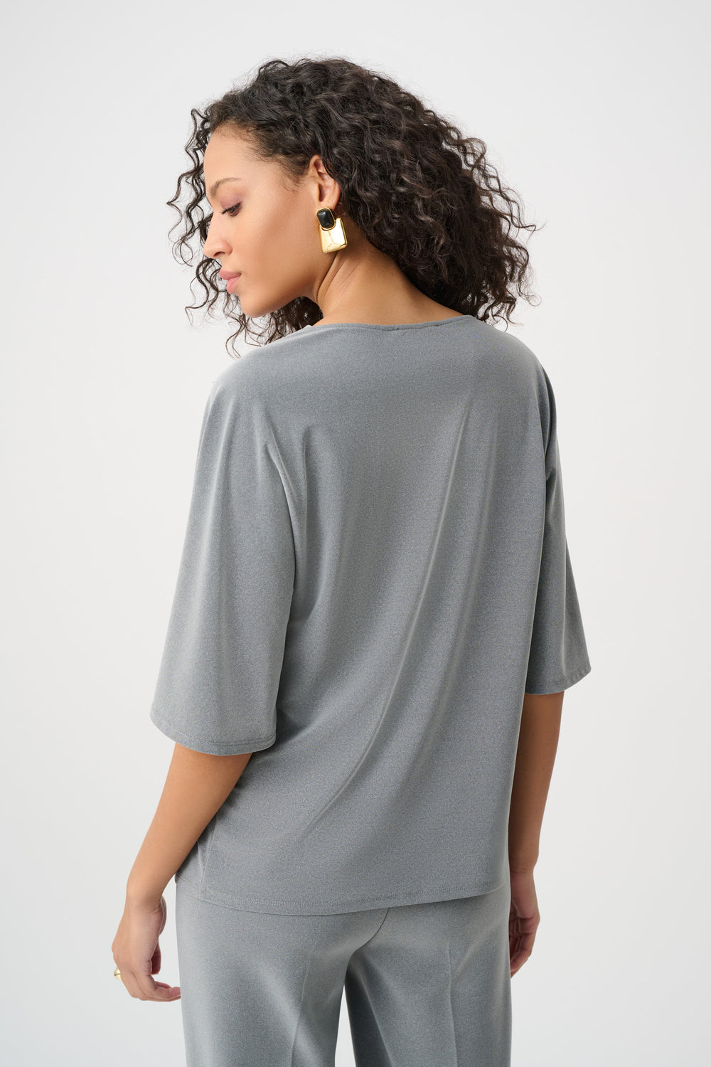 Woman wearing a gray outfit on a white background