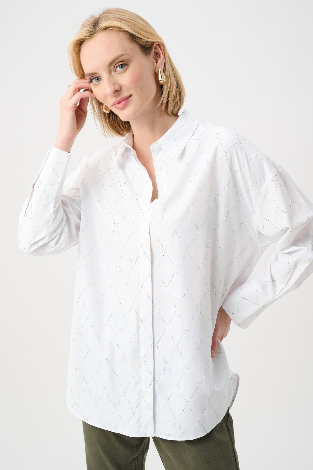 Woman wearing a white blouse against a white background
