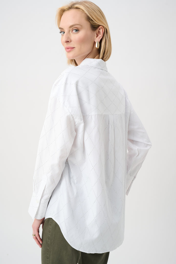 Woman wearing a light blue oversized shirt on a white background