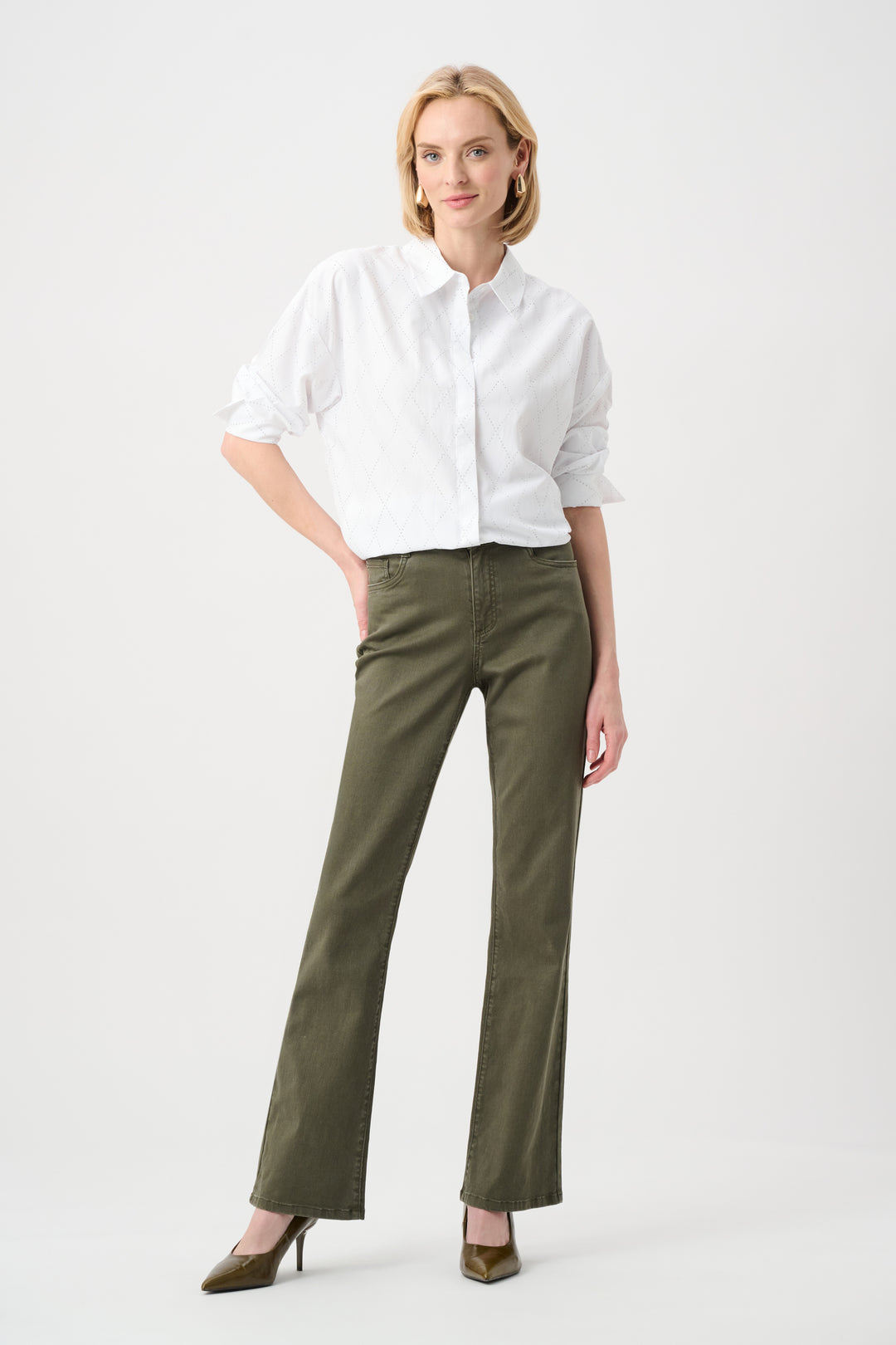 Woman wearing a white shirt and green pants on a white background