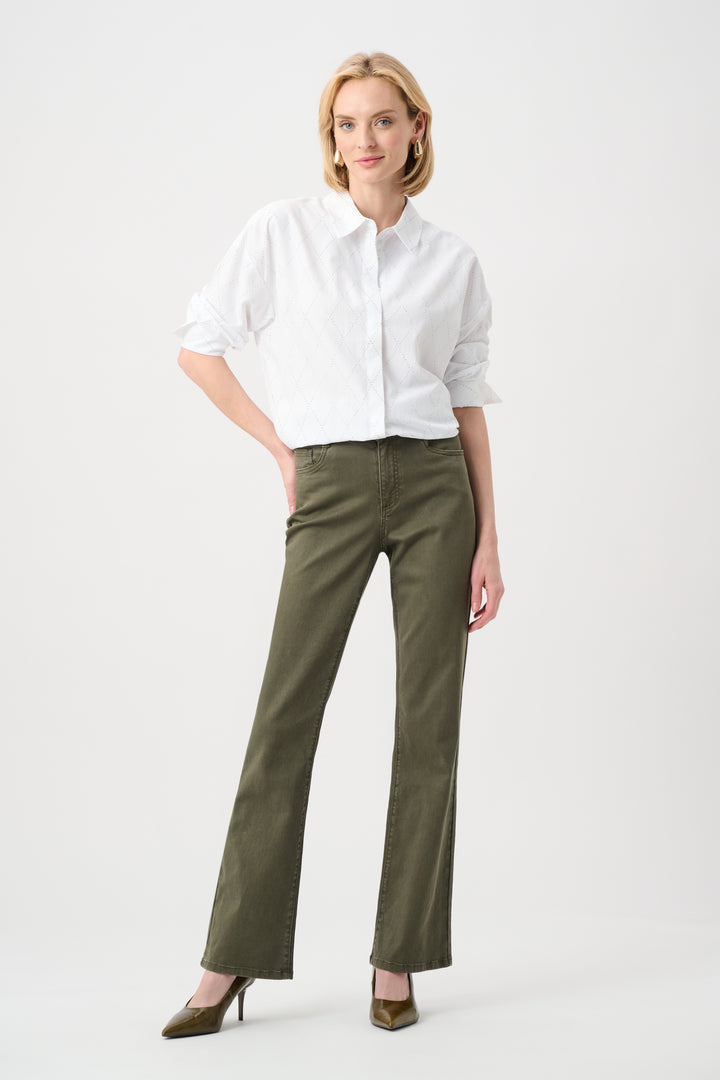Woman wearing a white shirt and green pants on a white background
