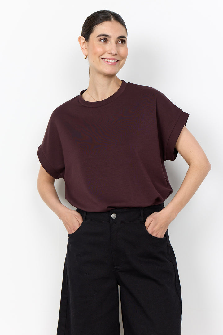woman wearing a casual t-shirt on a white background. 