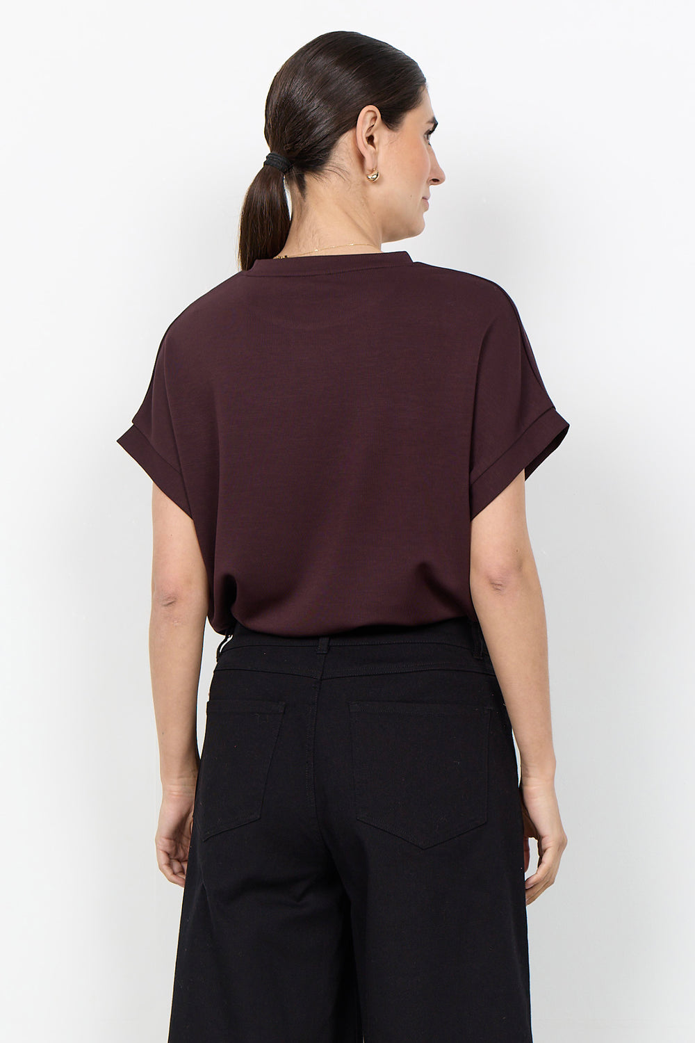 woman wearing a casual t-shirt on a white background. 