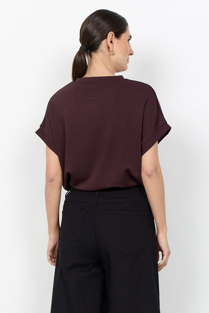woman wearing a casual t-shirt on a white background. 