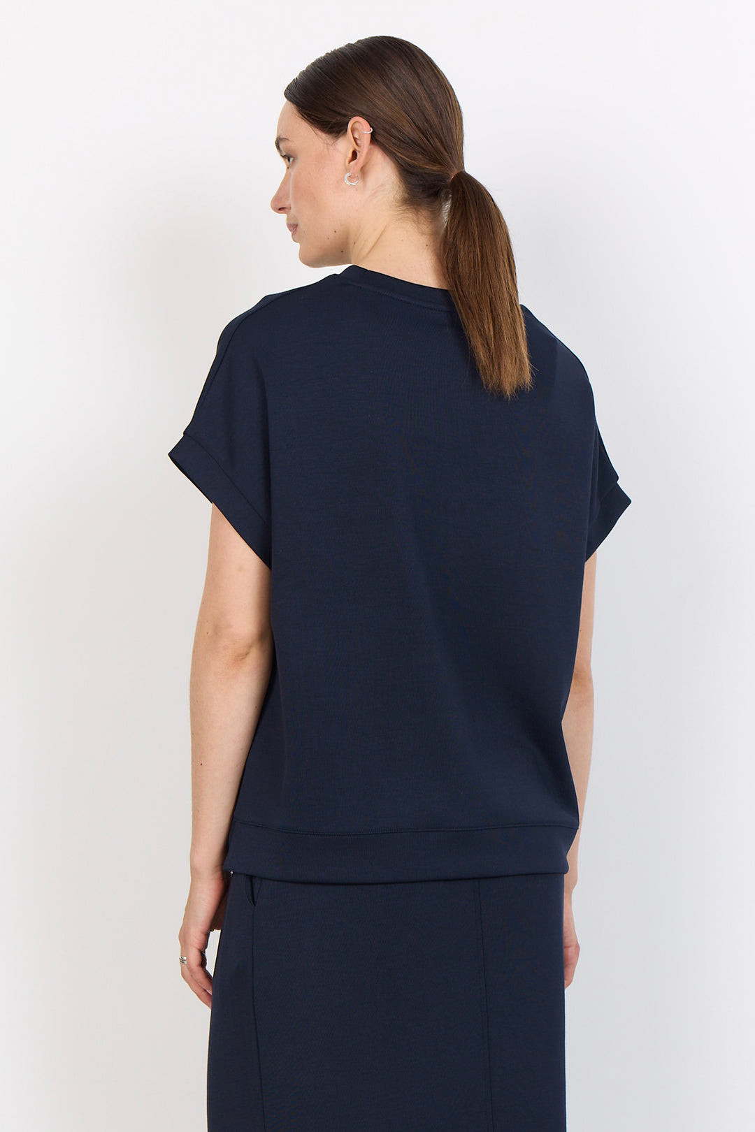 woman wearing a casual t-shirt on a white background. 