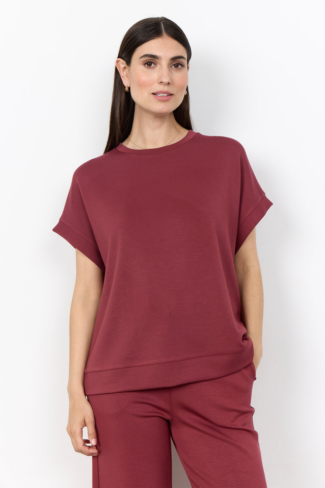 woman wearing a casual t-shirt on a white background. 