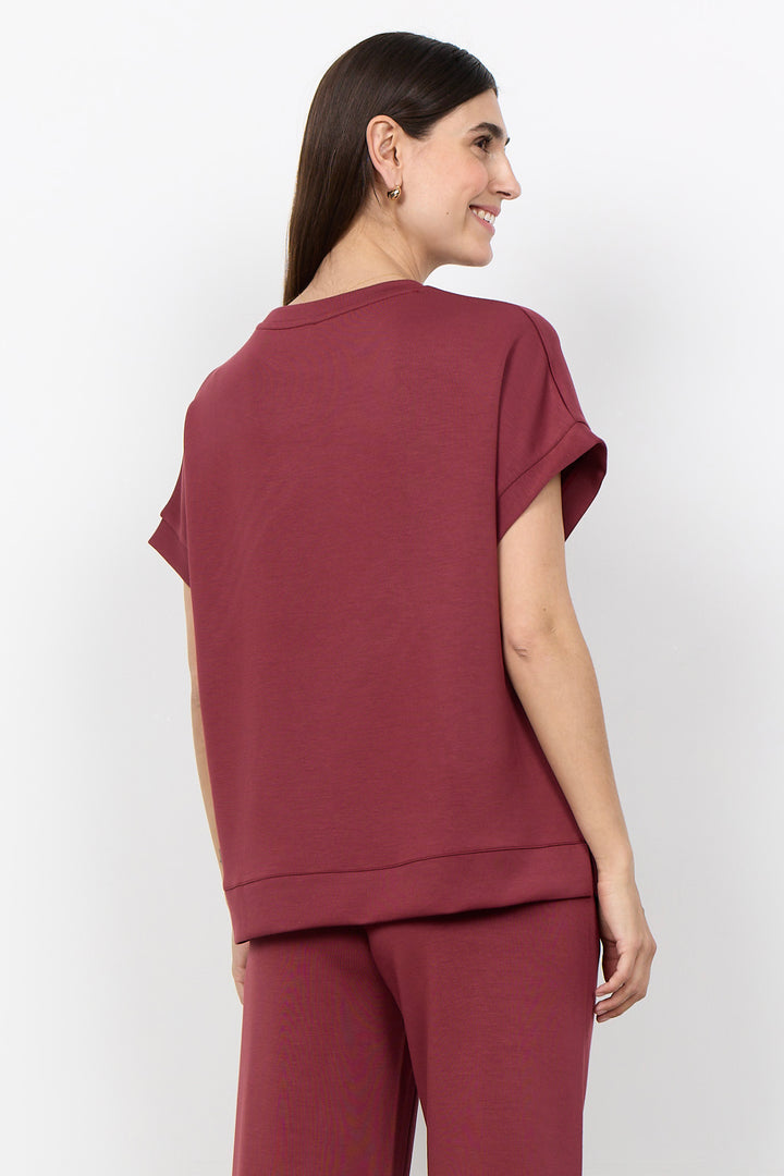 woman wearing a casual t-shirt on a white background. 