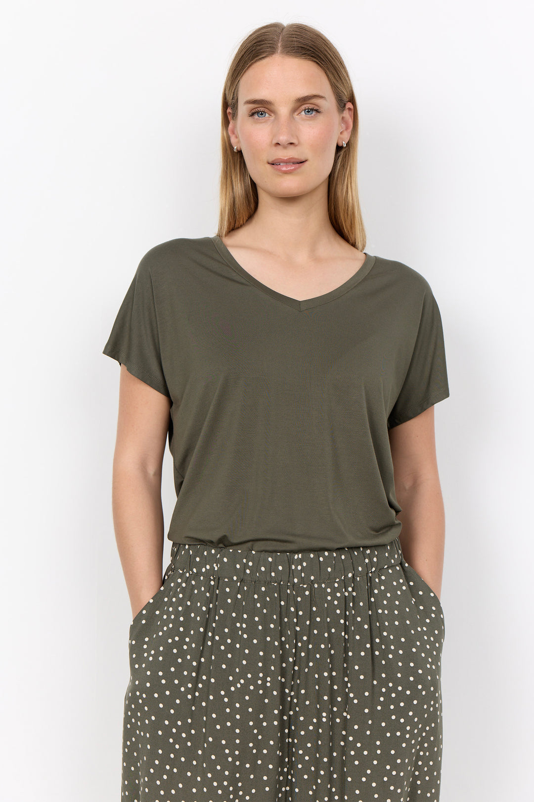 woman wearing a casual basic t-shirt on a white background. 