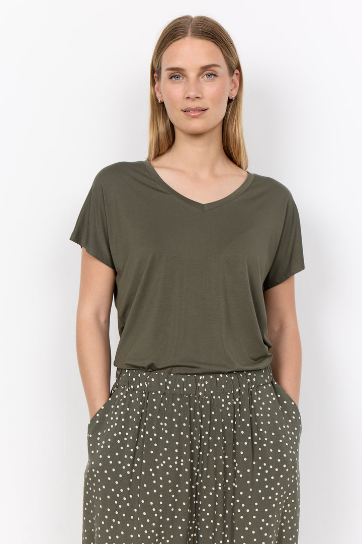 woman wearing a casual basic t-shirt on a white background. 