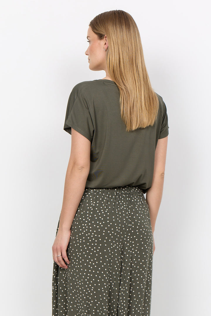 woman wearing a casual basic t-shirt on a white background. 