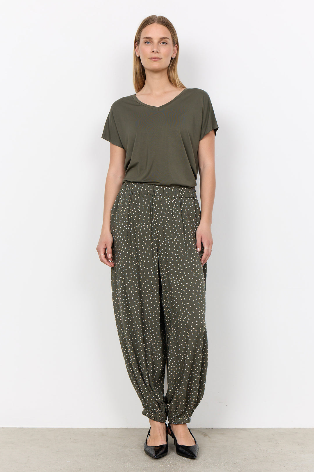 woman wearing a casual basic t-shirt on a white background. 