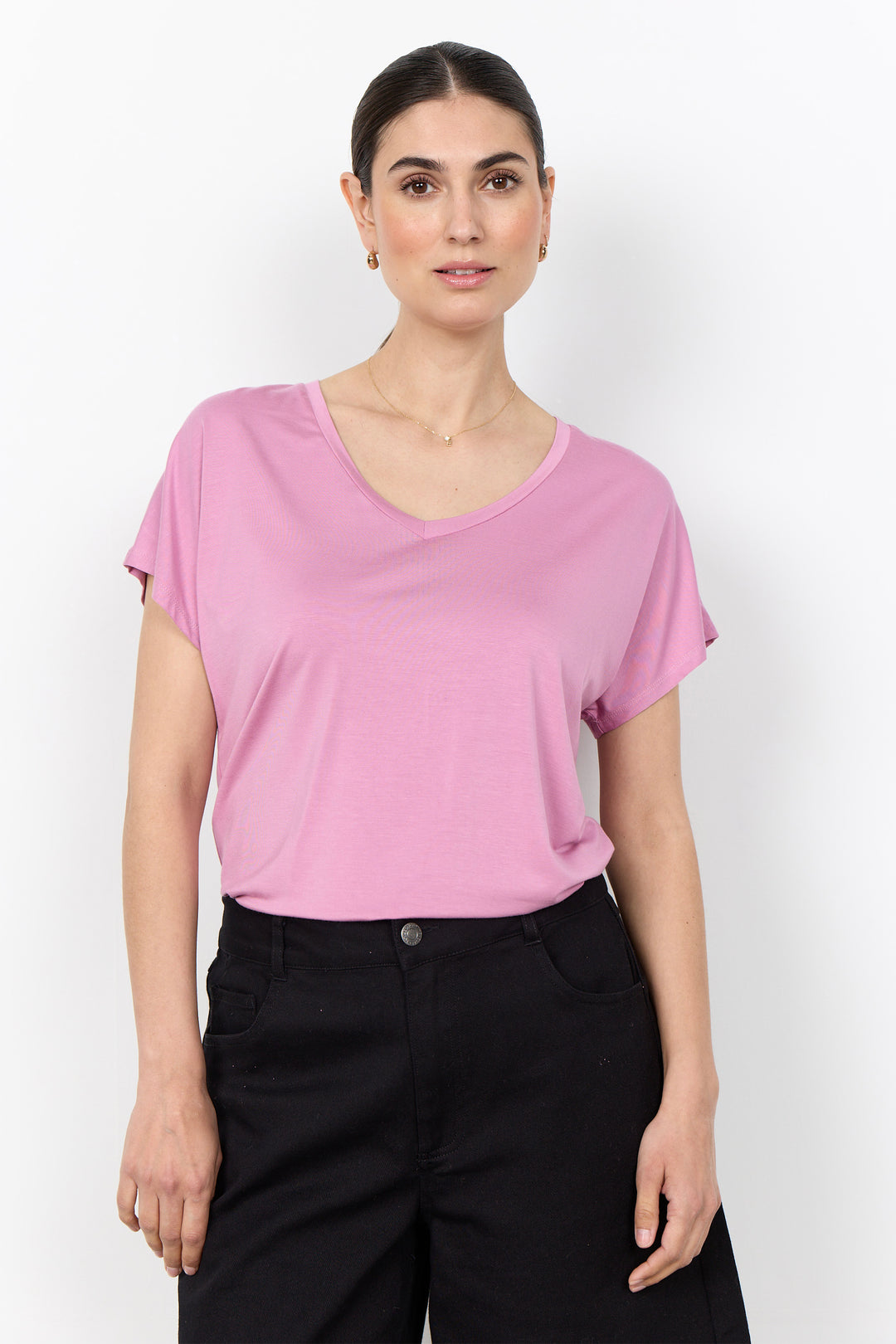 woman wearing a casual basic t-shirt on a white background. 