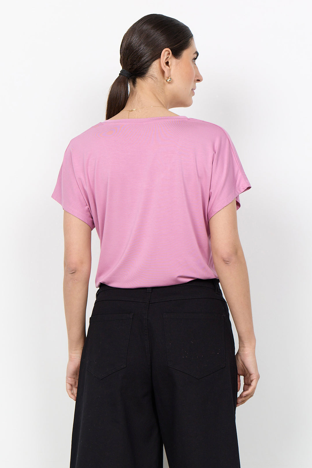 woman wearing a casual basic t-shirt on a white background. 