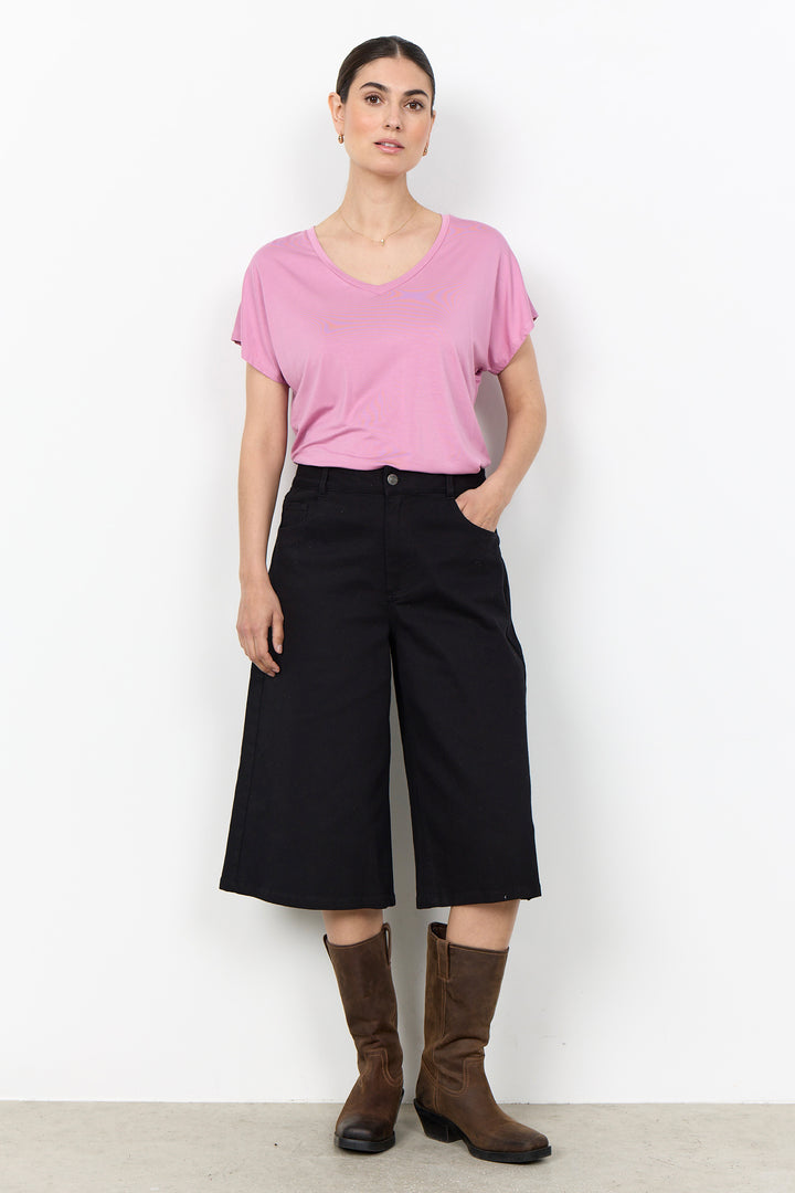 woman wearing a casual basic t-shirt on a white background. 