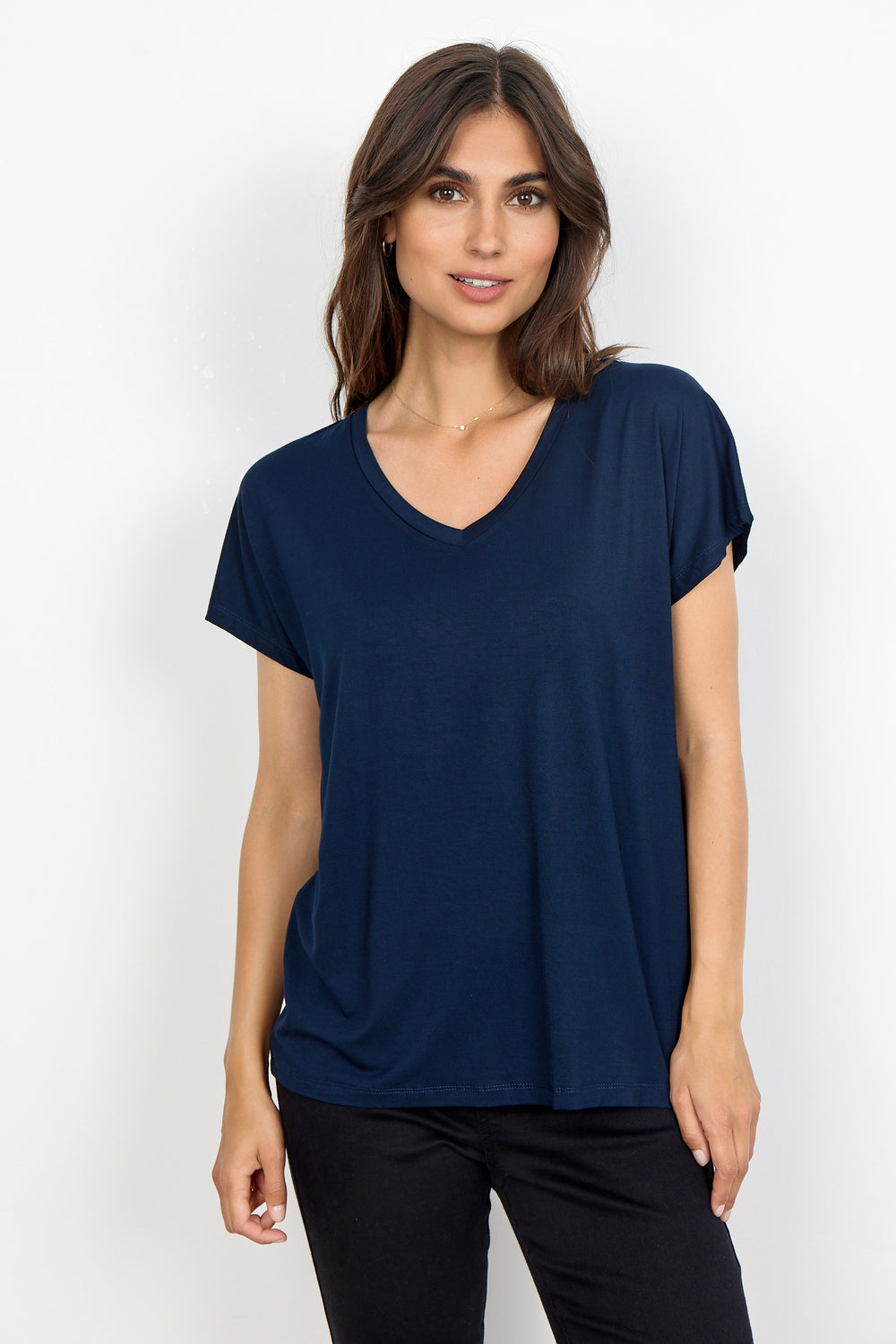 woman wearing a casual basic t-shirt on a white background. 