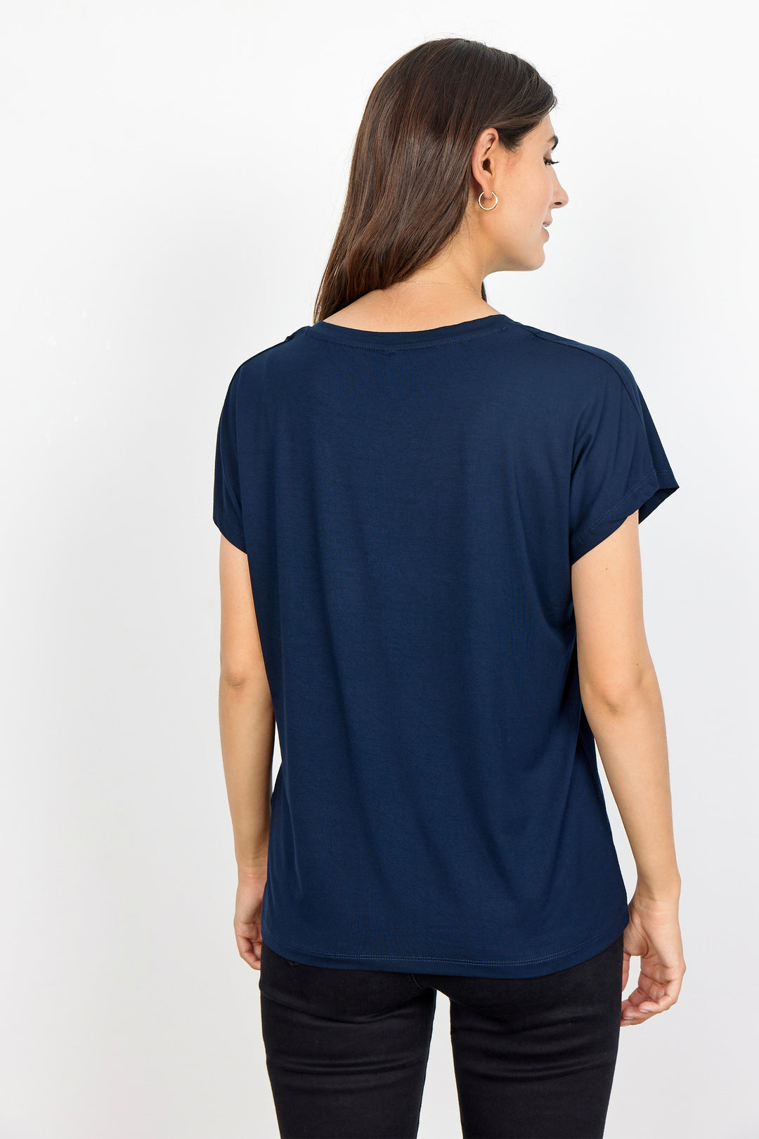woman wearing a casual basic t-shirt on a white background. 