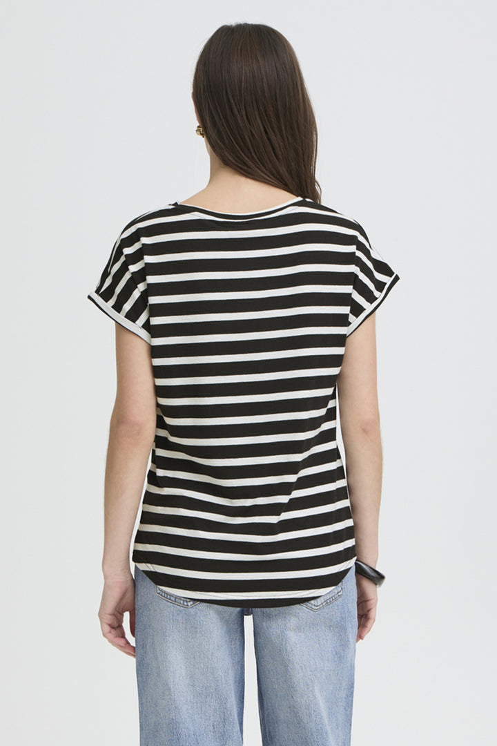 A woman viewed from the back wearing a black and white horizontally striped short-sleeve t-shirt and light blue jeans, set against a plain light gray studio background.