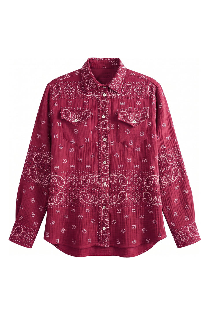 A long-sleeve button-up shirt in a deep burgundy red, featuring a white paisley bandana print and two chest pockets with decorative button flaps.