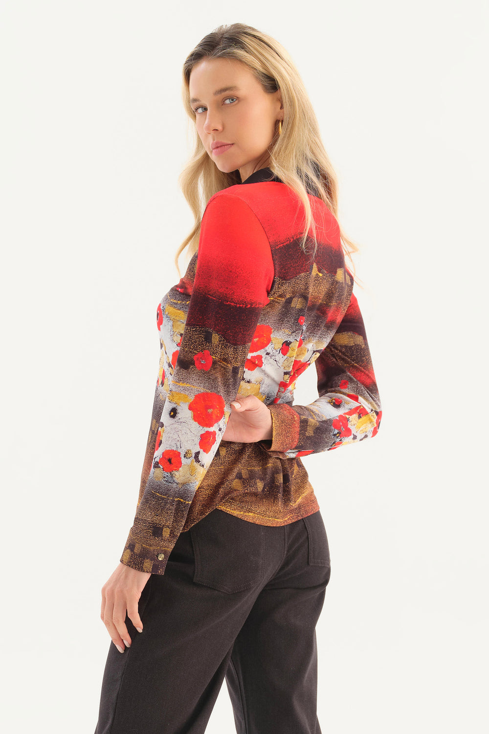 A women modelling the back of a long sleeve collared shirt with red and brown floral print in front of a white background. 