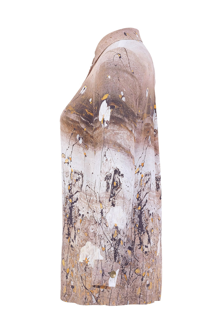 A long-sleeve collared shirt shown from the side on a white background, featuring an abstract art print with brown, beige, white, and gold paint splatters.