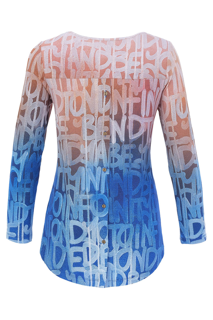 A top with an ombré gradient transitioning from peach-pink at the top to light blue and dark blue at the bottom, covered in a white graffiti-style text pattern, shown on a white background.