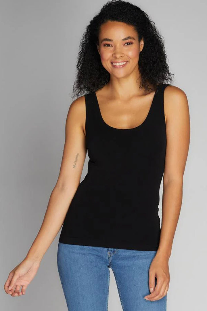 Woman wearing a black tank top on white background