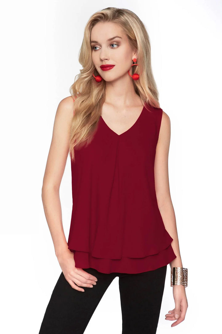 Women wearing a sleeveless layered blouse in front of white background