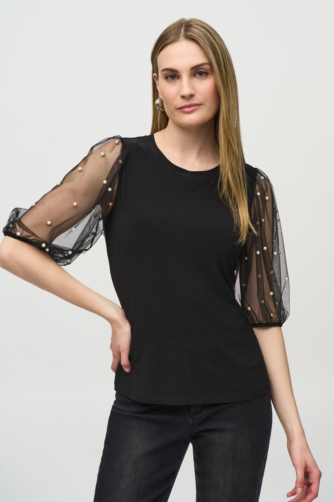 Joseph Ribkoff Fall 2024 This top exudes elegance and glamour, boasting classy see through puffy 3/4 length sleeves adorned with stunning pearl bling studs.