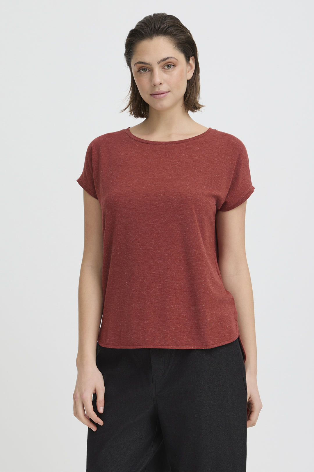 Woman wearing a rust-colored round neckline t-shirt against a white background