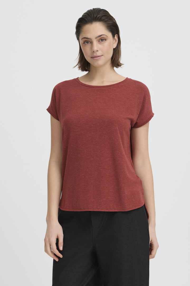 Woman wearing a rust-colored round neckline t-shirt against a white background