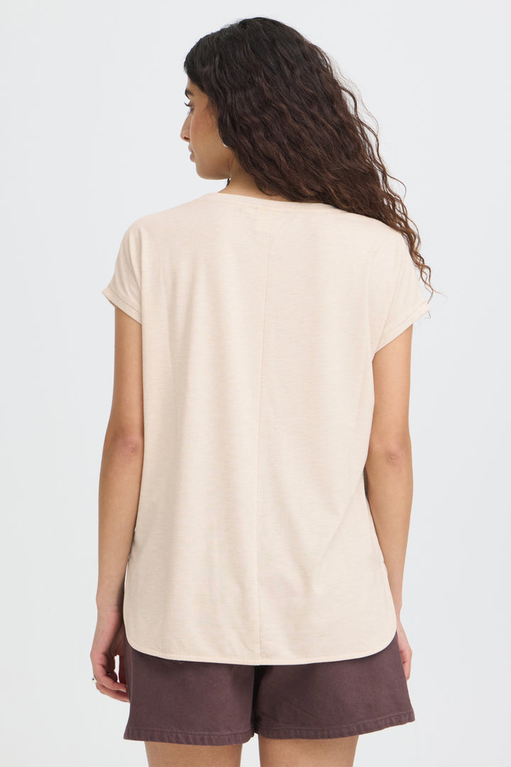 Woman wearing a beige t-shirt and brown shorts on a white background