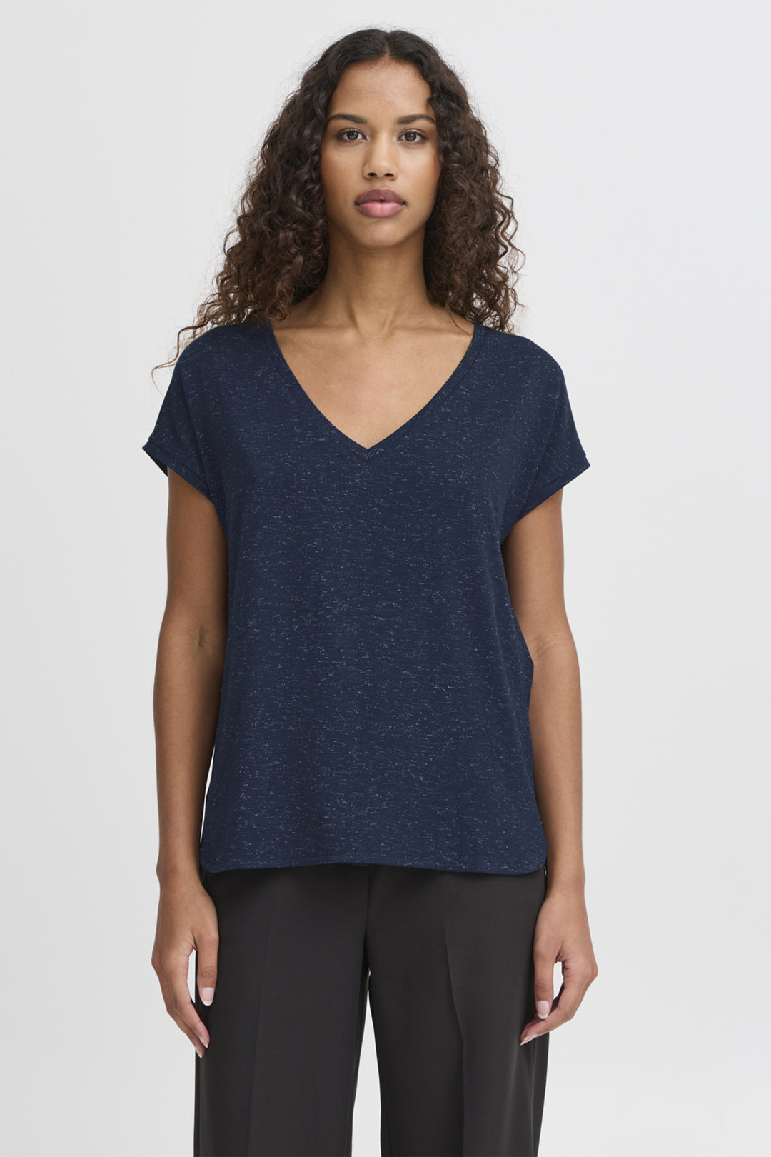 Woman wearing a navy blue t-shirt against a white background