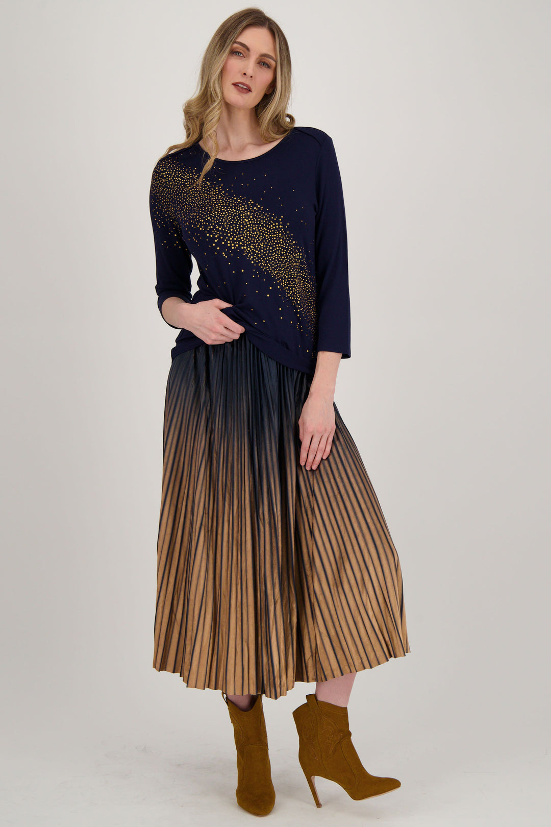 Spanner Fall 2024 This pleated maxi skirt in a nice fall colour tone is the perfect addition to your wardrobe. Featuring a comfortable elastic waistband for easy slip on styling, pair it with a nice sweater top for a stylish and effortless look.