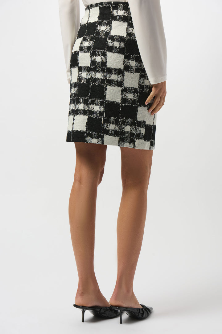 Person wearing a black and white checkered mini skirt on a white background