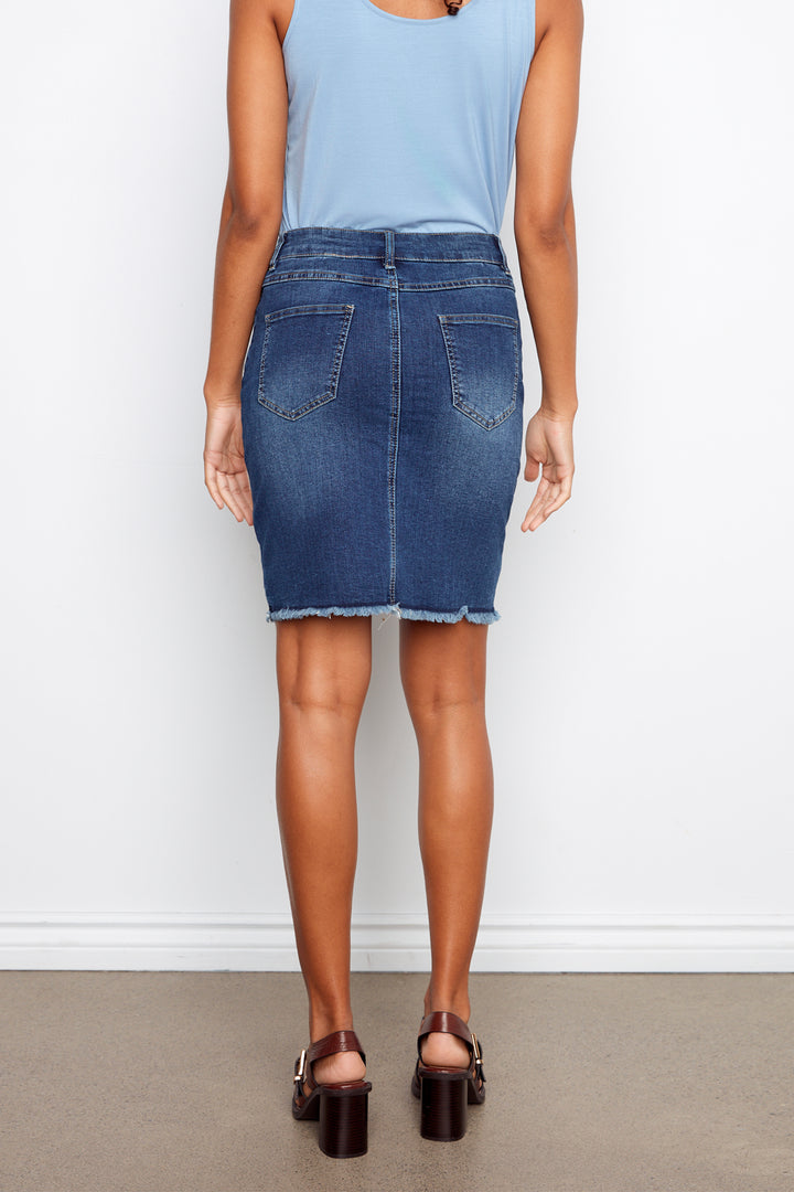Person wearing a blue denim skirt and light blue top against a white background