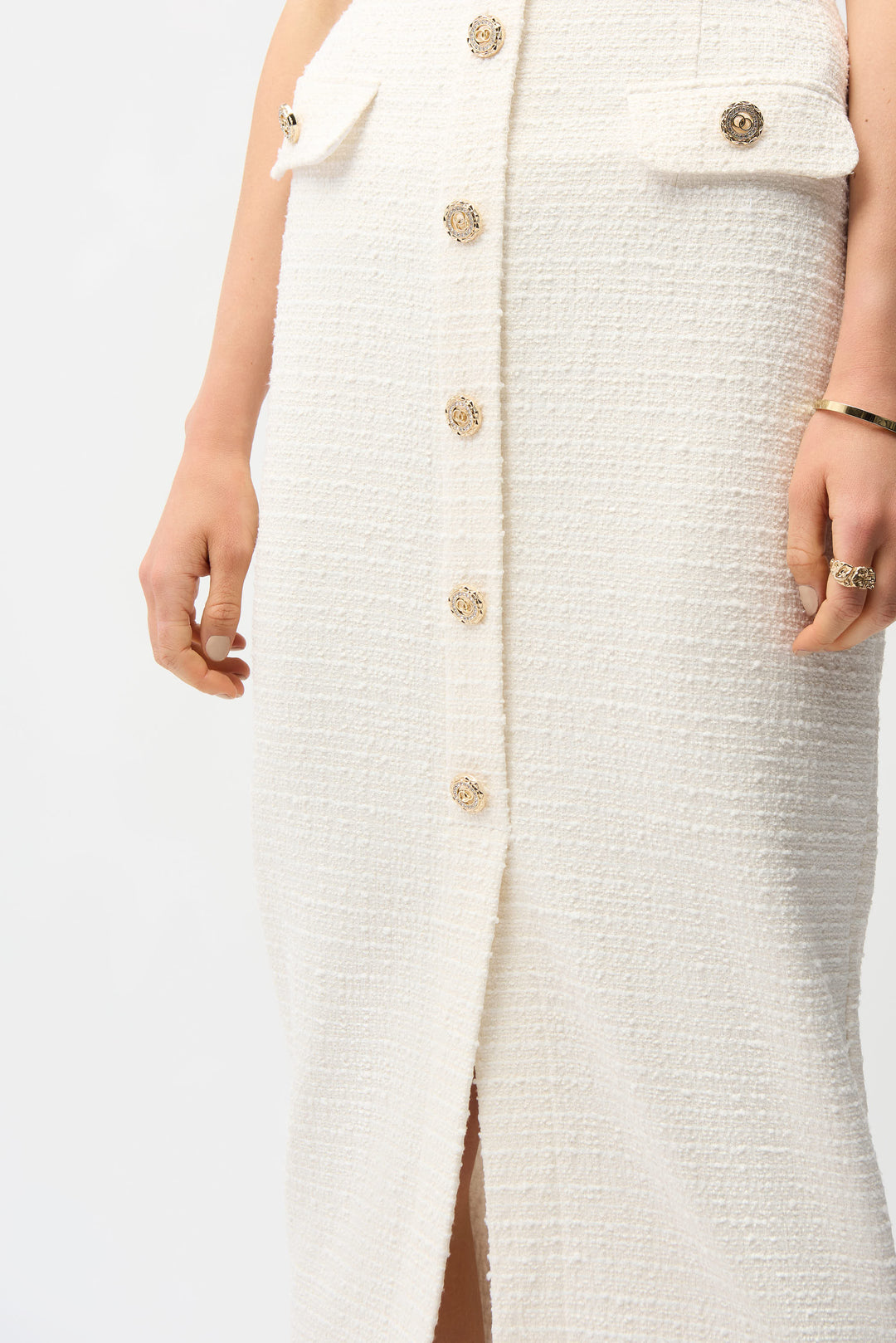 White textured dress with gold buttons on a white background