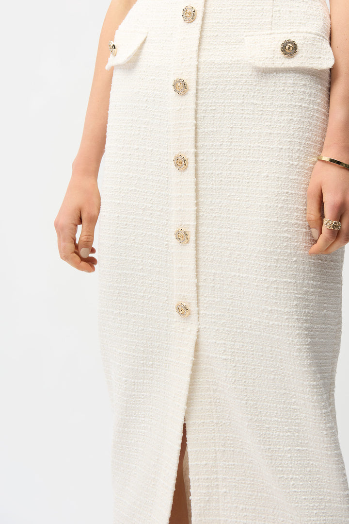 White textured dress with gold buttons on a white background