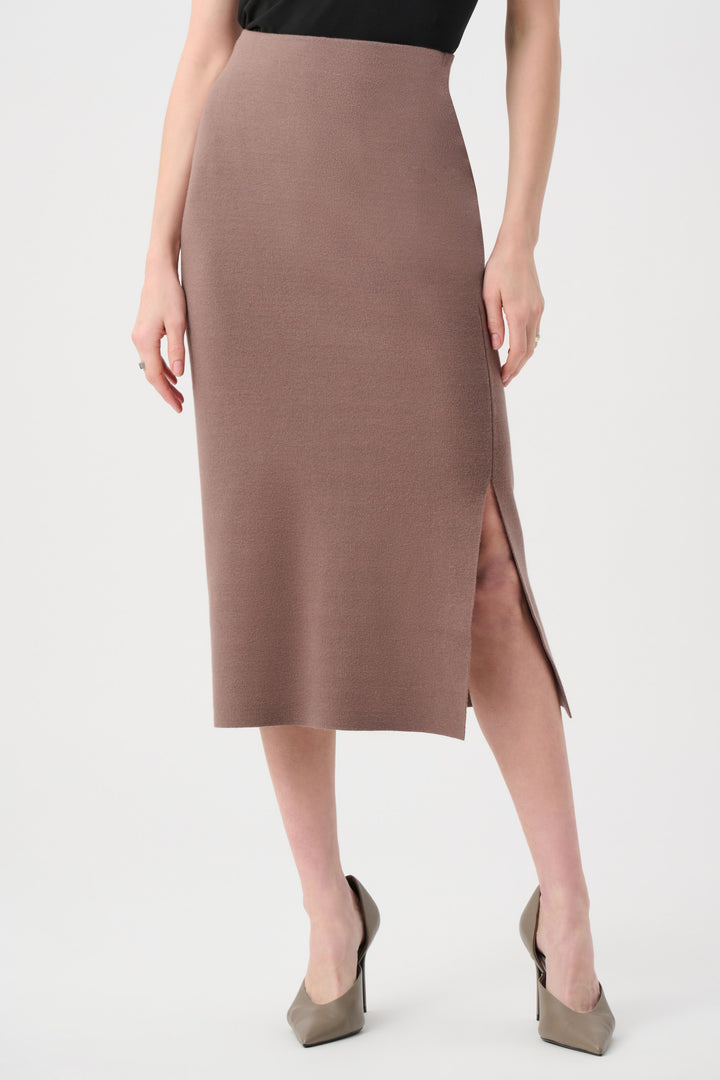 Woman wearing a brown skirt with a slit on a white background
