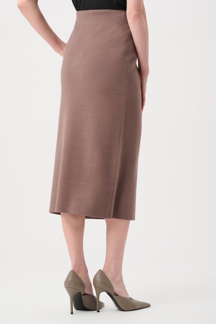 Person wearing a brown skirt on a white background