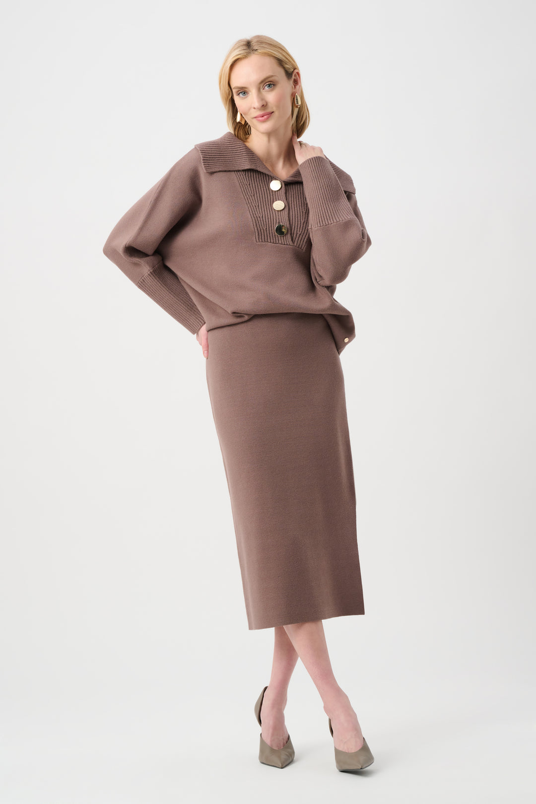Woman wearing a brown outfit with a top and skirt on a white background