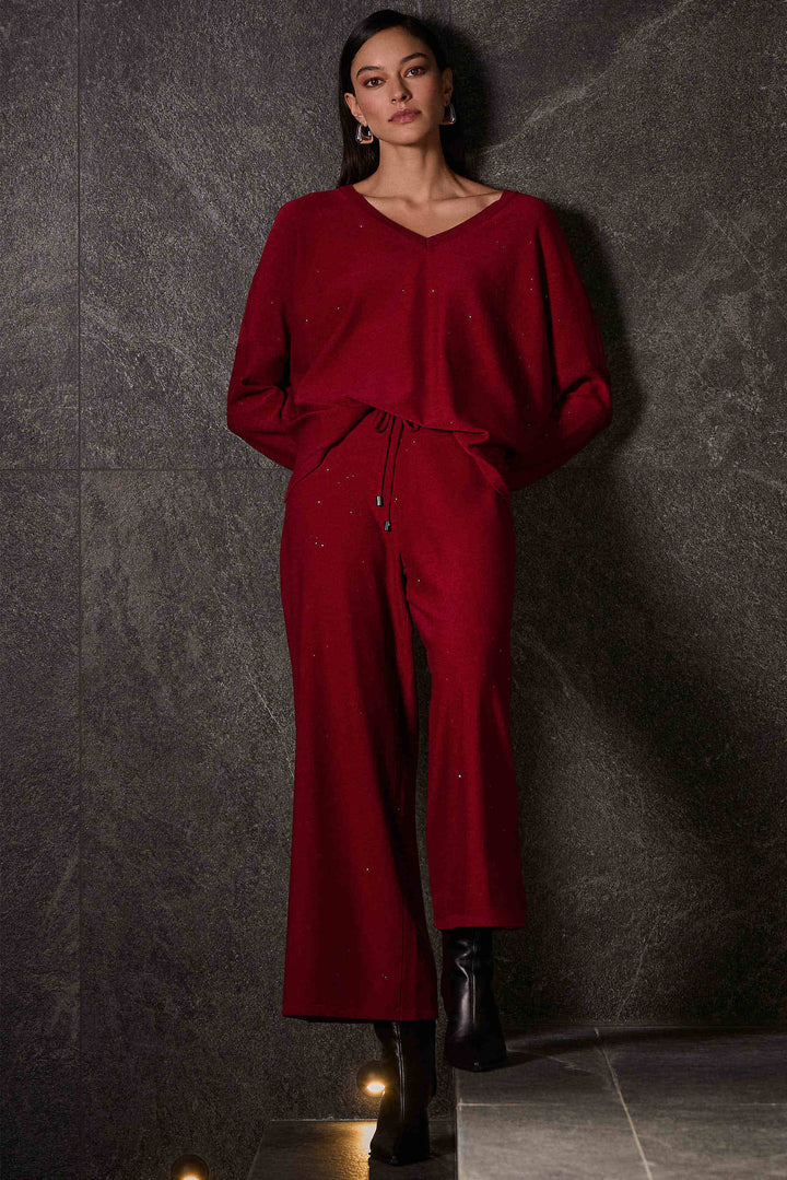  Joseph Ribkoff Fall 2025 
Effortlessly stylish with its sparkly design and wide-leg pants, these culottes offer comfort and convenience with its elastic waistband. You won't want to take them off! 