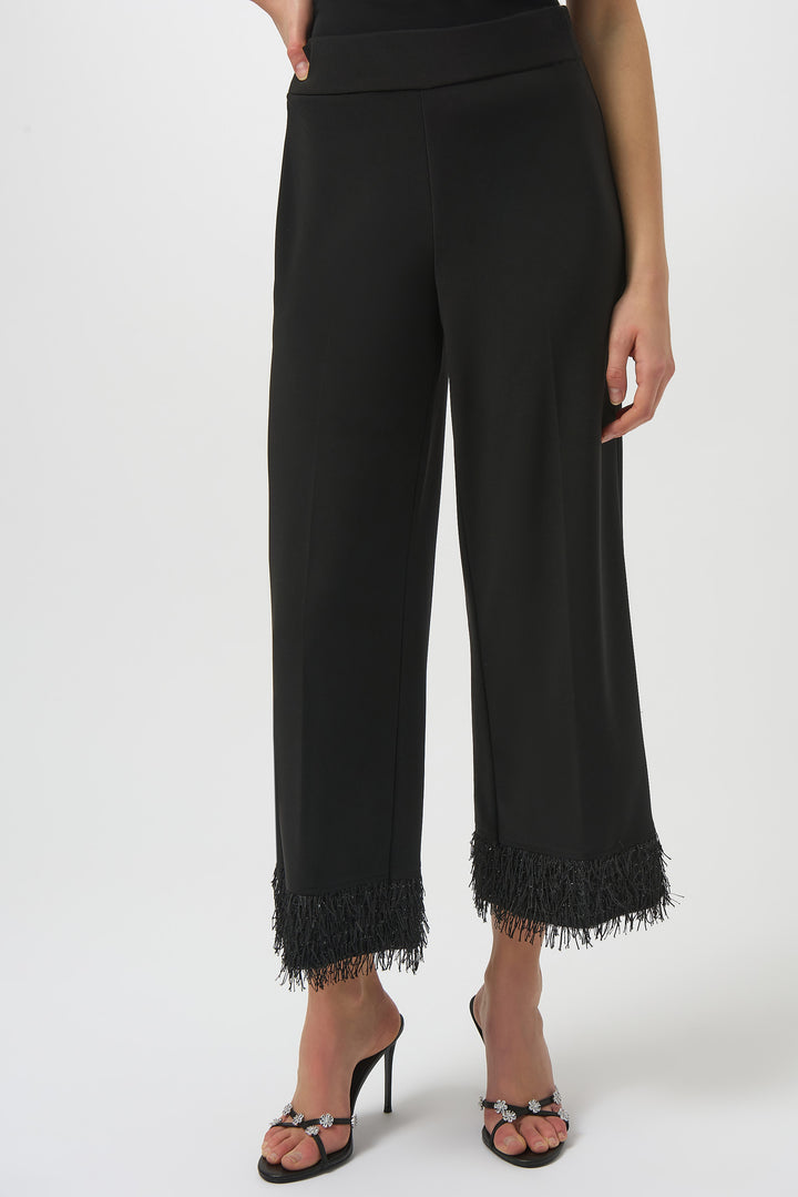 Joseph Ribkoff Fall 2025 
Elevate your wardrobe with these black high-rise culotte pants featuring a standout fringe hem. Perfectly tailored for a sophisticated silhouette, they transition effortlessly from day to night.