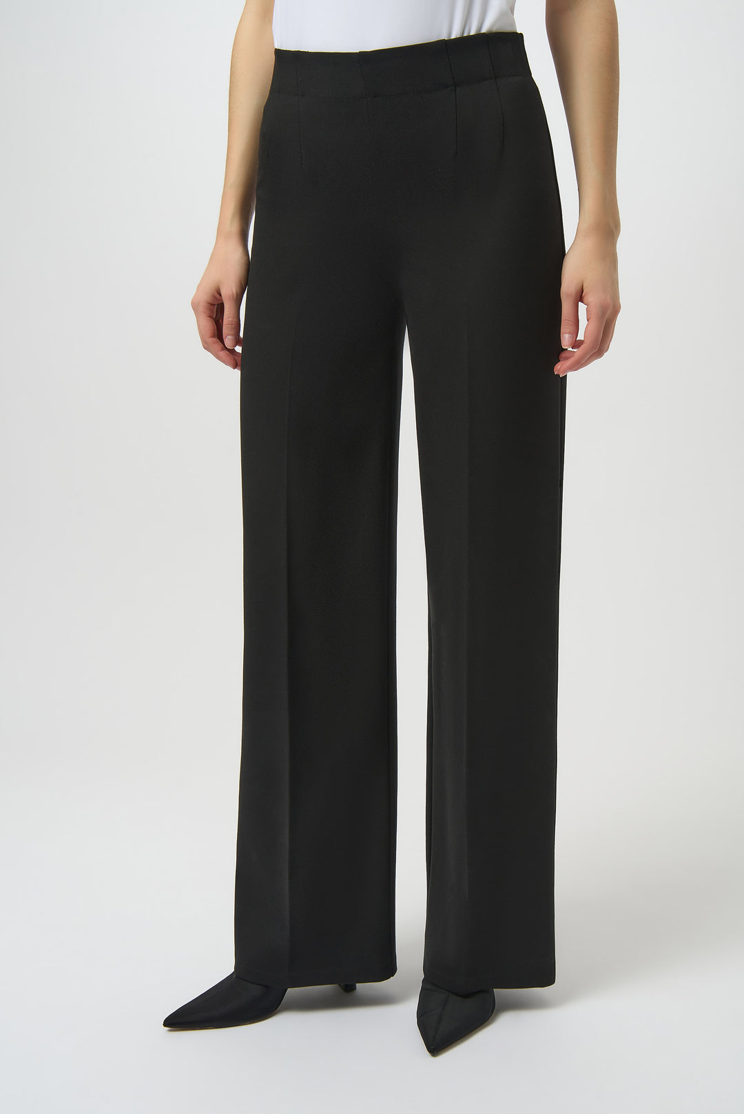 Black wide-leg pants worn by a person on a white background