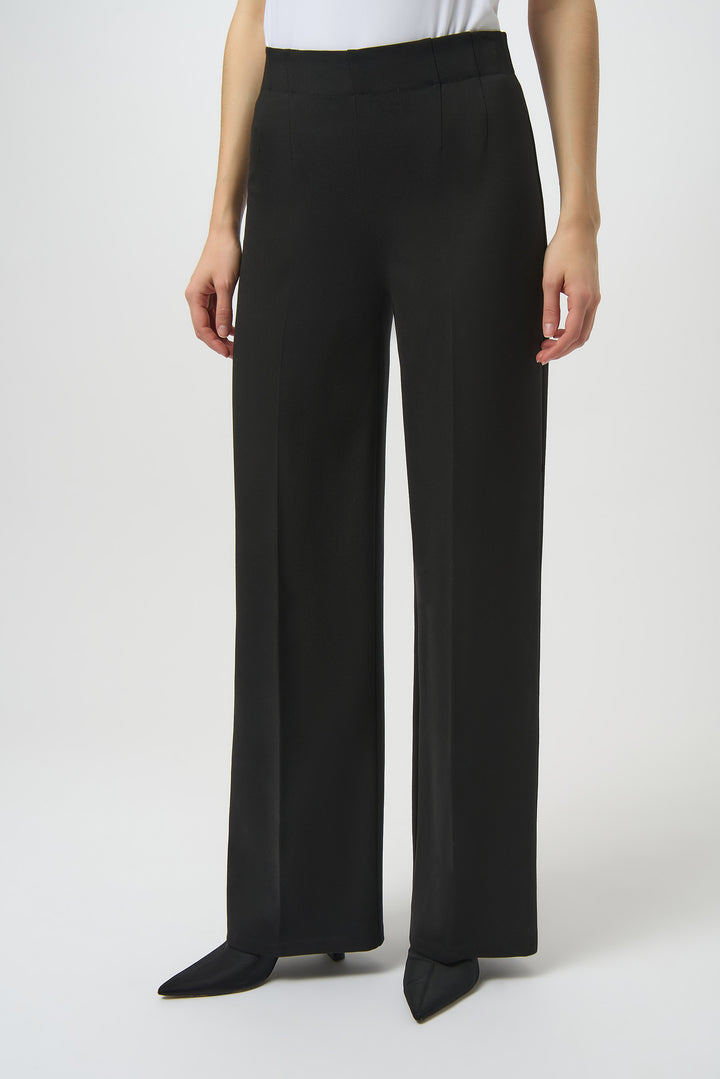 Black wide-leg pants worn by a person on a white background