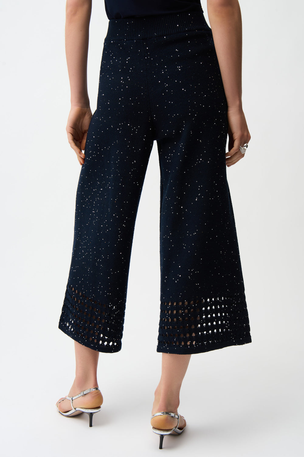 Navy wide-leg pants with crochet pattern on a white background