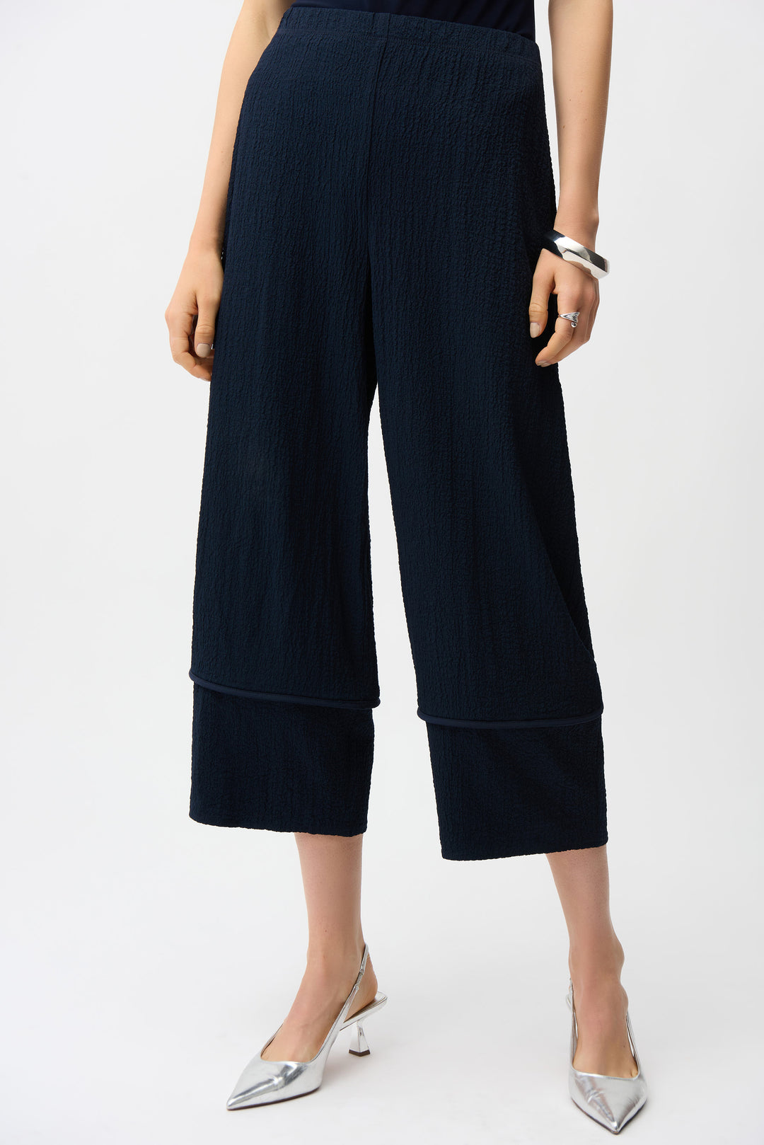 Navy blue pull-on wide-leg pants worn by a person on a white background