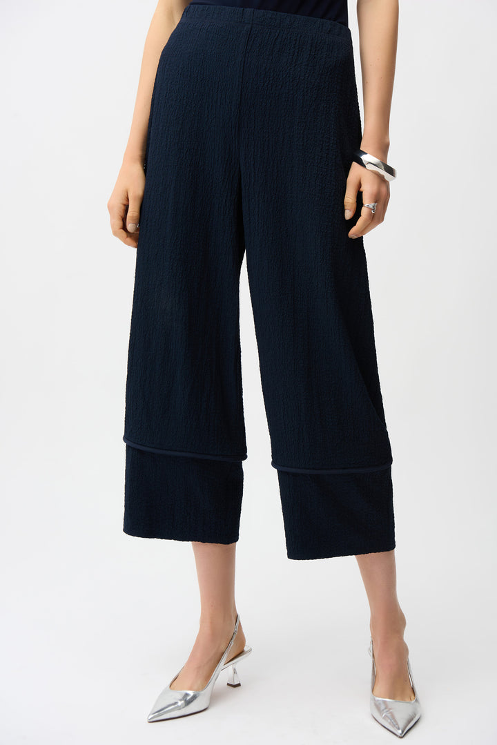 Navy blue pull-on wide-leg pants worn by a person on a white background