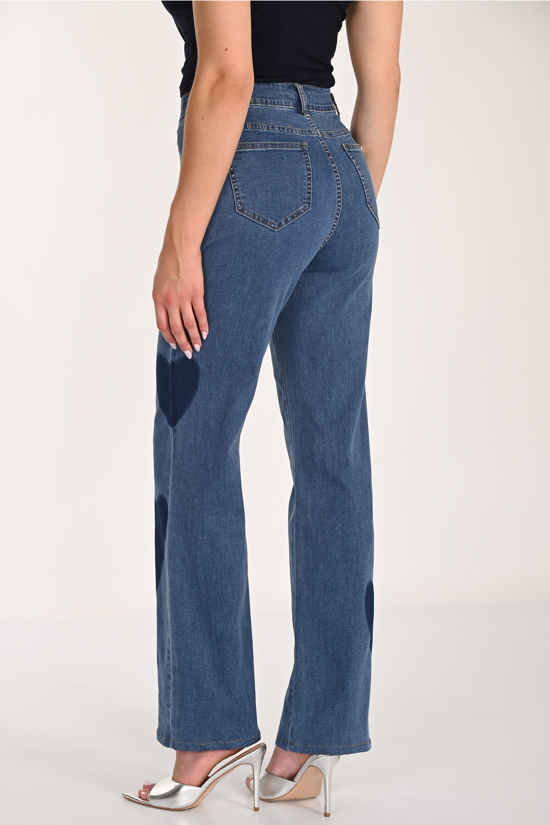 Person wearing blue jeans on a white background